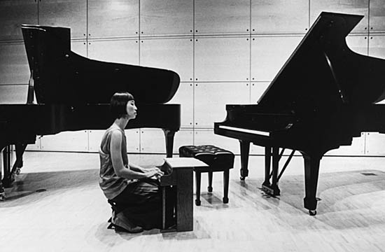 Margaret Leng Tan playing a toy piano in a concert